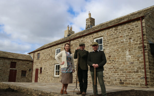 Members of Beamish Museum's staff stand outside Spain's Field Farm