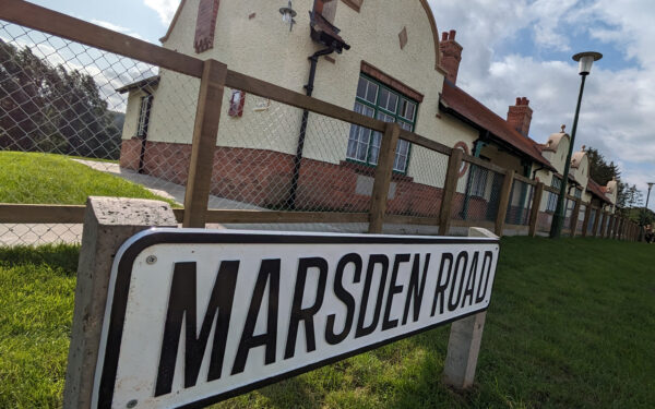 Four aged minworkers' homes. In the foreground is a street sign which reads Marsden Road